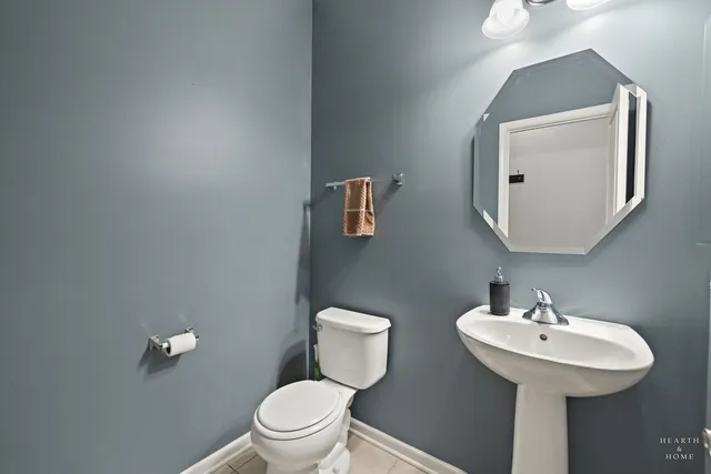a bathroom with a toilet a sink and mirror