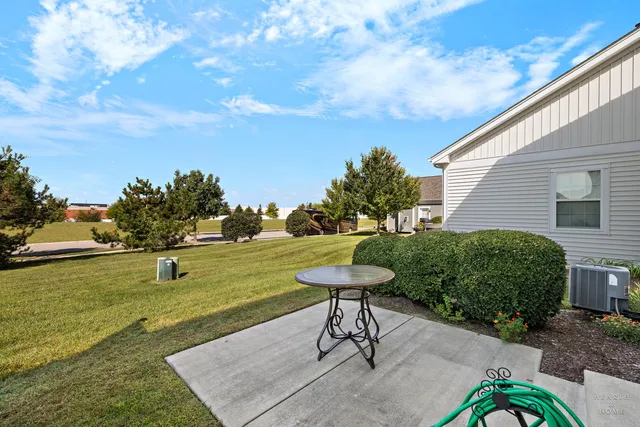 a view of a backyard with plants and outdoor seating