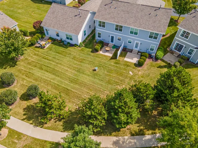 an aerial view of residential houses with yard