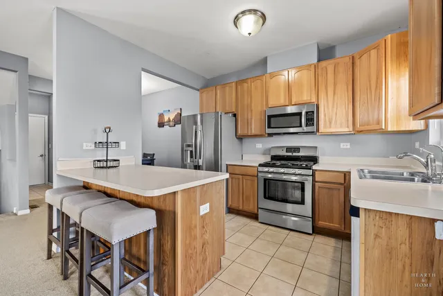 a kitchen with a stove a sink and a refrigerator