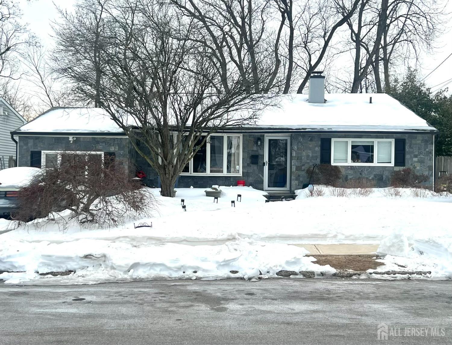 47 Westminster Road Colonia, NJ 07067 - Photo 1 of 1 a front view of a house with a yard covered in snow