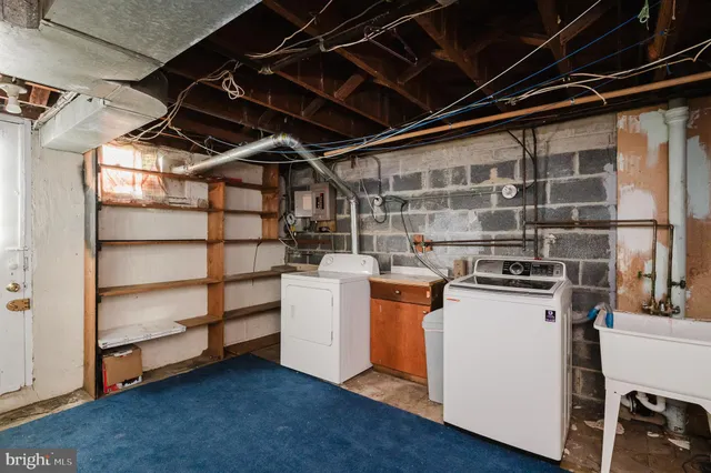 a view of storage and utility room with washer and dryer
