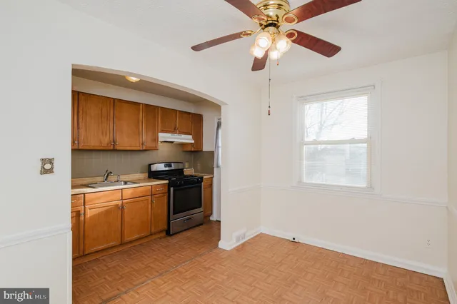 a kitchen with a sink cabinets stainless steel appliances and a window