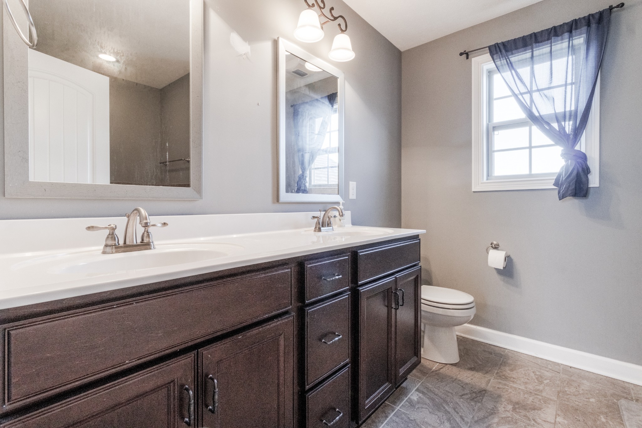 3794 Suiter Road Clarksville, TN 37040 - Photo 14 of 26 a bathroom with a granite countertop sink a toilet and a window