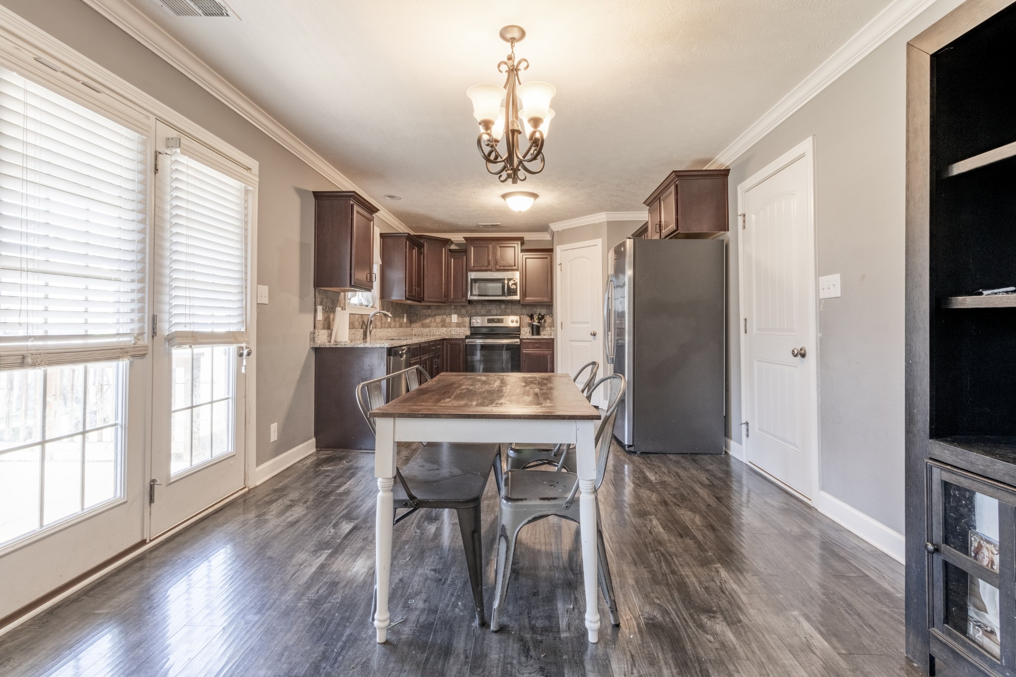 3794 Suiter Road Clarksville, TN 37040 - Photo 9 of 26 a kitchen with stainless steel appliances a dining table chairs refrigerator and cabinets