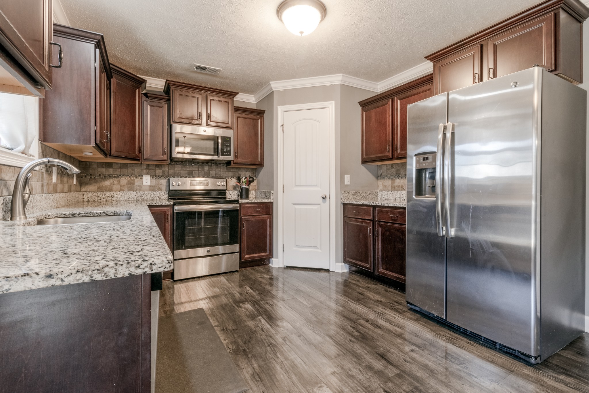 3794 Suiter Road Clarksville, TN 37040 - Photo 10 of 26 a kitchen with stainless steel appliances granite countertop a refrigerator a sink a stove and oven