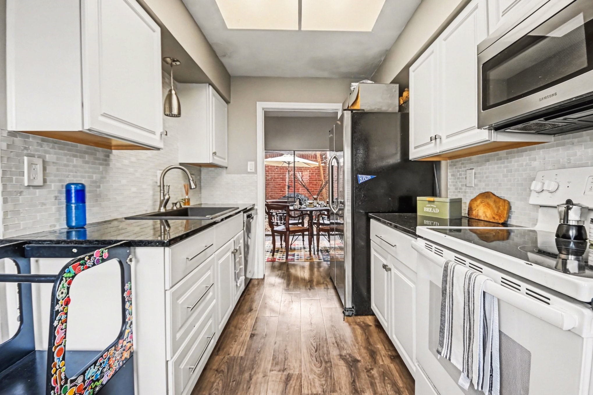 7447 Cambridge Street, Unit 73 Houston, TX 77054 - Photo 12 of 27 a kitchen with stainless steel appliances granite countertop a sink and cabinets