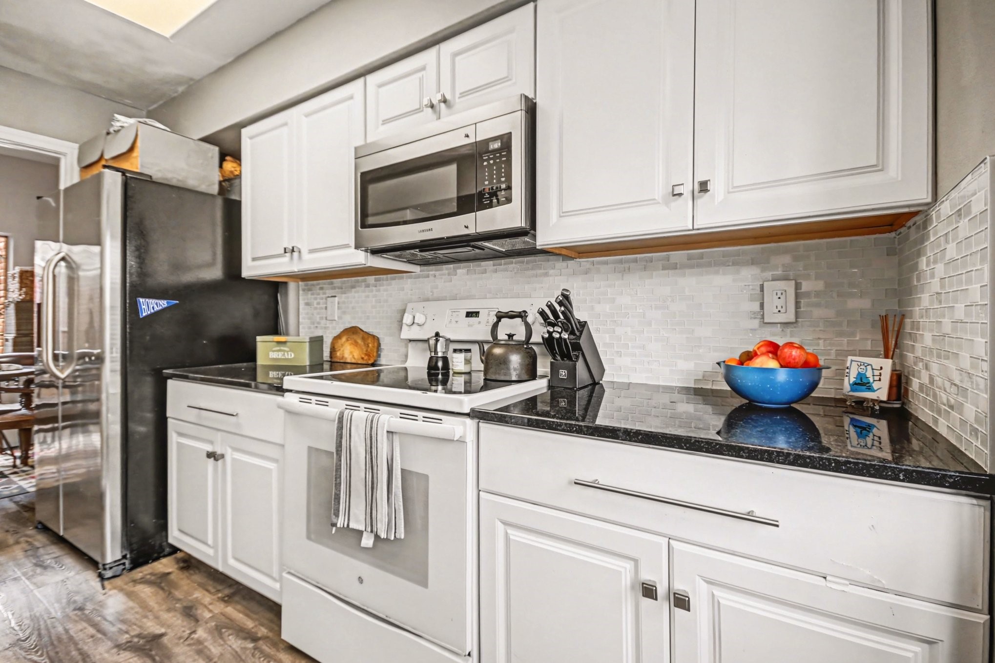 7447 Cambridge Street, Unit 73 Houston, TX 77054 - Photo 13 of 27 a kitchen with stainless steel appliances granite countertop white cabinets a sink and dishwasher