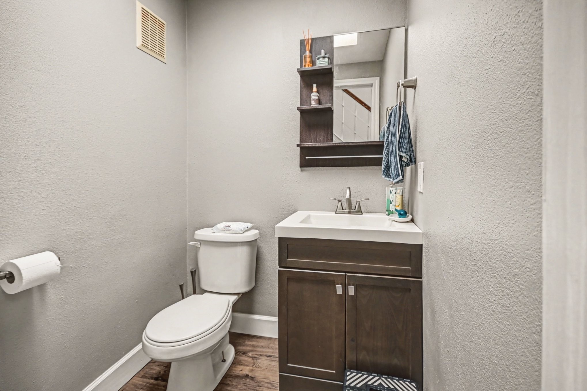 7447 Cambridge Street, Unit 73 Houston, TX 77054 - Photo 15 of 27 a bathroom with a toilet sink and mirror