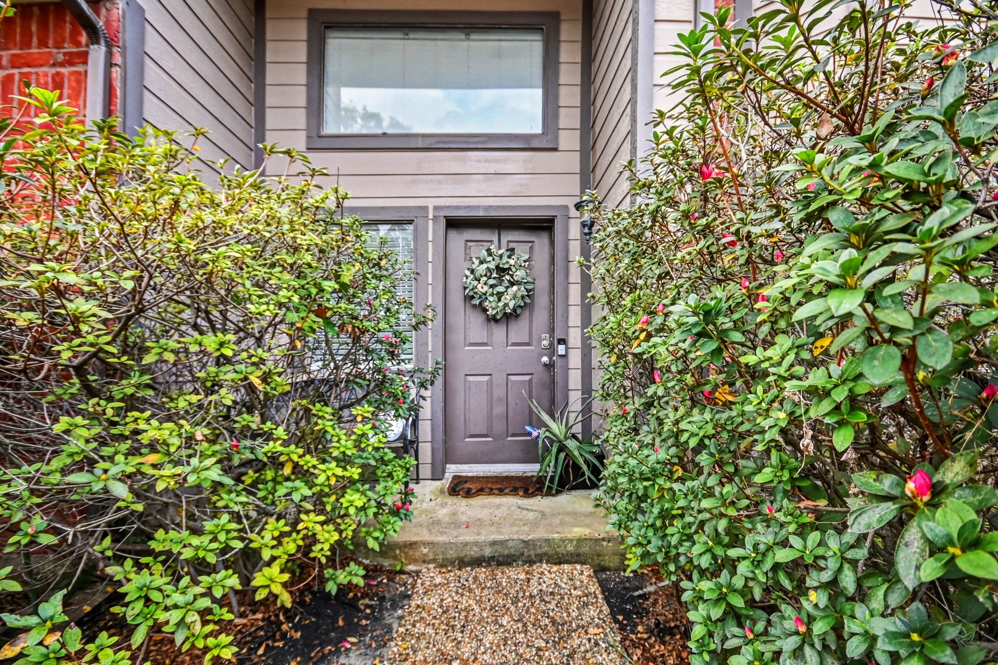 7447 Cambridge Street, Unit 73 Houston, TX 77054 - Photo 2 of 27 a front view of a house with a plant