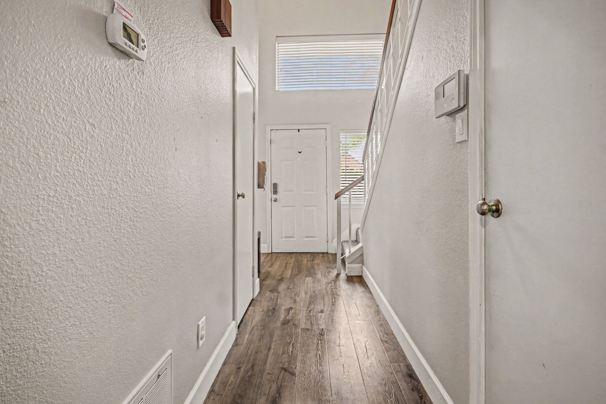 7447 Cambridge Street, Unit 73 Houston, TX 77054 - Photo 3 of 27 a view of a hallway with wooden floor and staircase