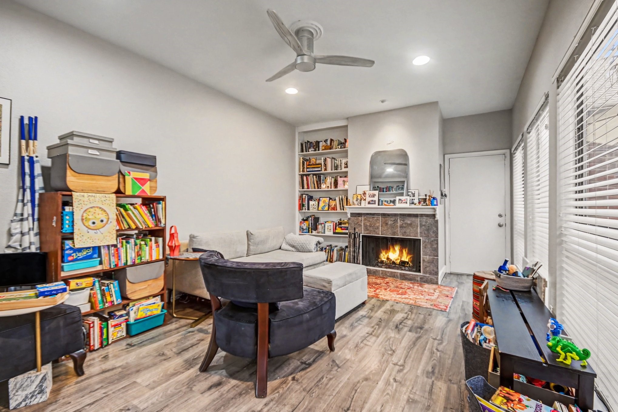 7447 Cambridge Street, Unit 73 Houston, TX 77054 - Photo 8 of 27 a living room with furniture a fireplace and a flat screen tv