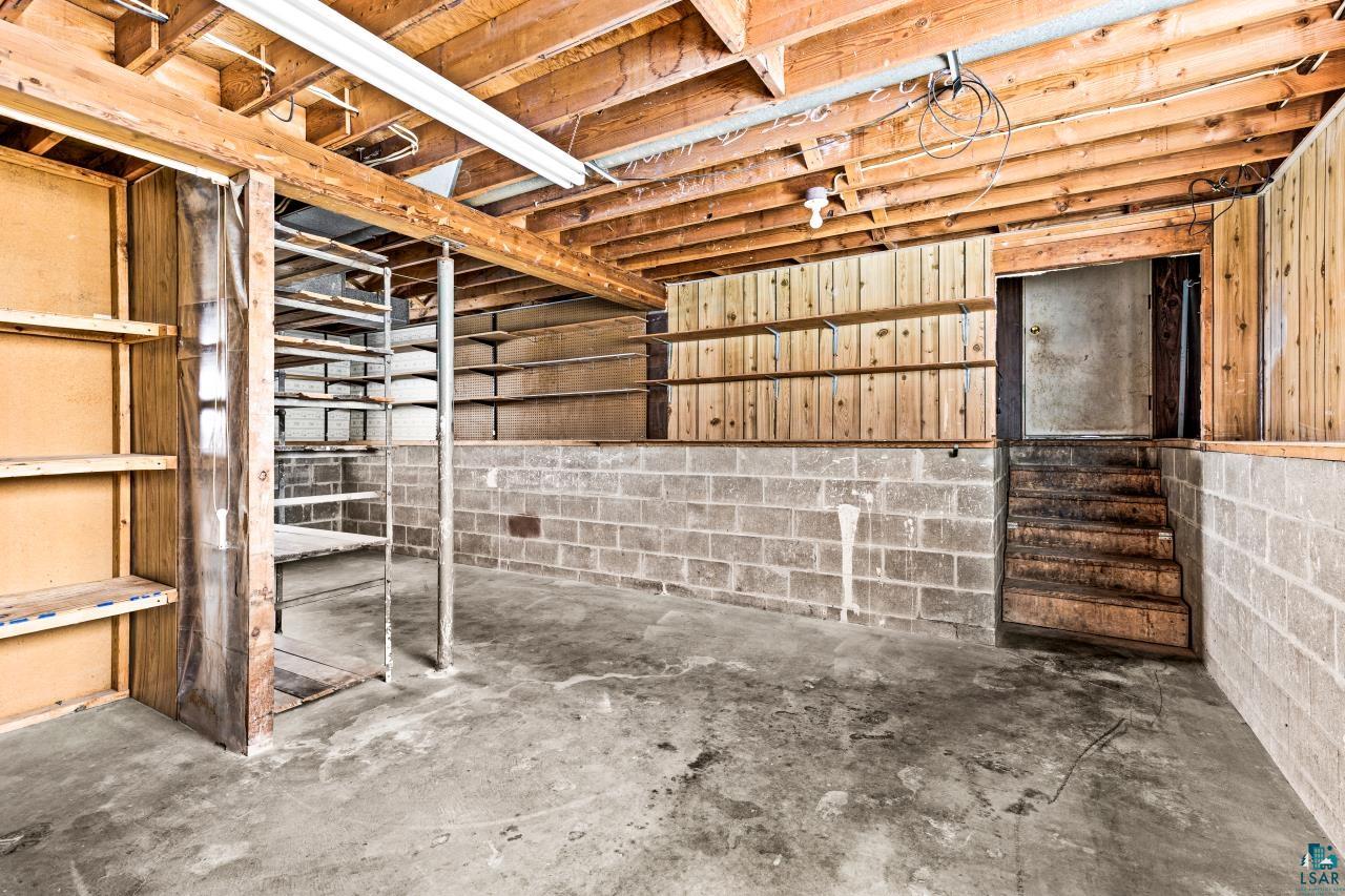 6606 Metso Road Kettle River, MN 55757 - Photo 79 of 84 Unfinished basement with concrete flooring and exposed wood ceiling joists