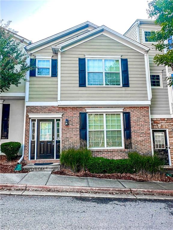 139 Riverstone Commons Circle Canton, GA 30114 - Photo 27 of 28 a front view of a house with a garden and plants
