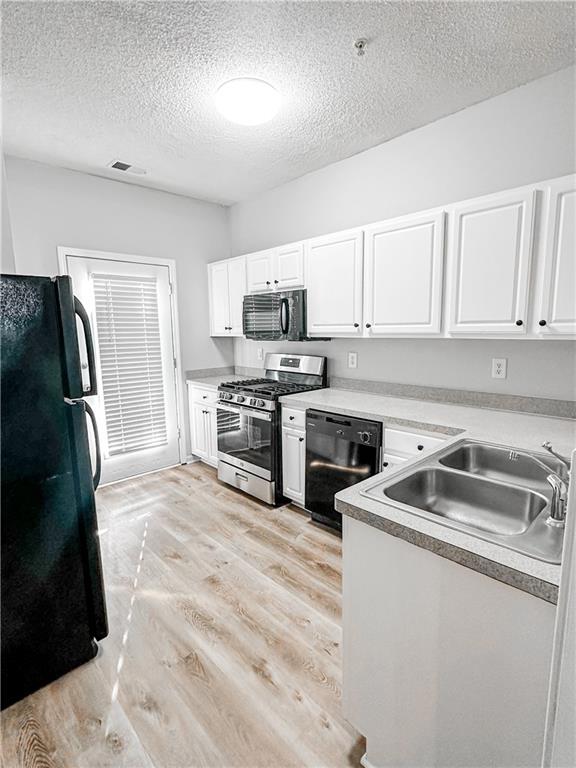 139 Riverstone Commons Circle Canton, GA 30114 - Photo 6 of 28 a kitchen with a sink stove and refrigerator