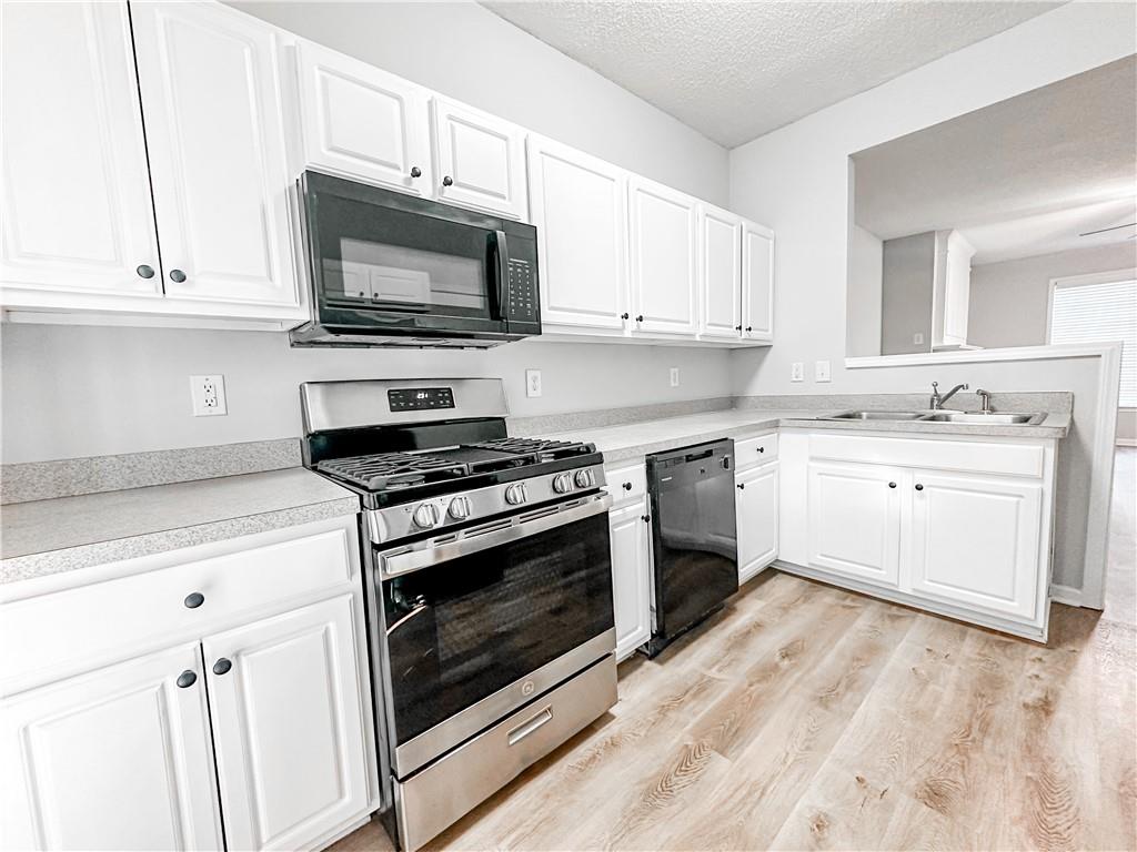 139 Riverstone Commons Circle Canton, GA 30114 - Photo 7 of 28 a kitchen with a stove and a microwave