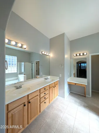 a spacious bathroom with a tub sink and mirror