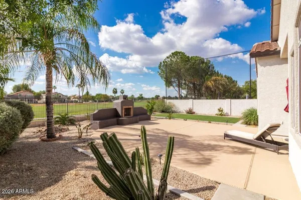 a view of a backyard with swimming pool and sitting area