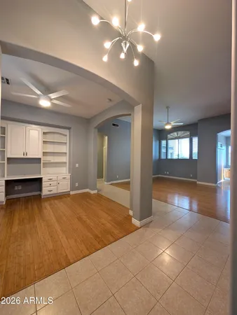 a view of an empty room with window and cabinet
