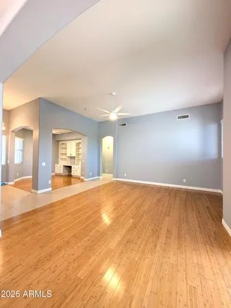 a view of empty room with wooden floor