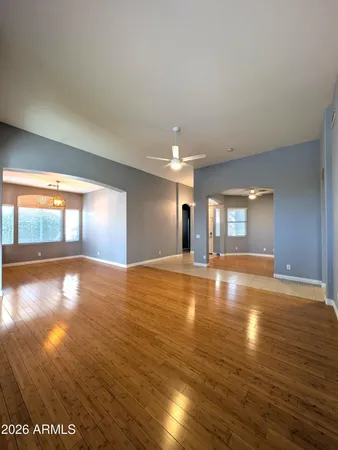a view of empty room with wooden floor