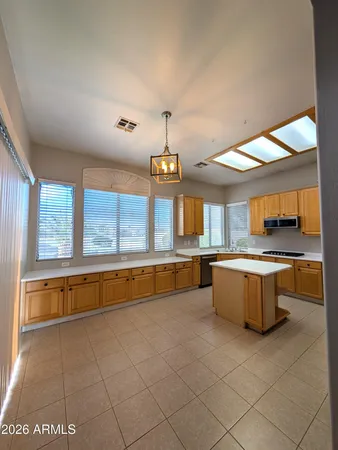 a large kitchen with kitchen island granite countertop a large counter top and sink
