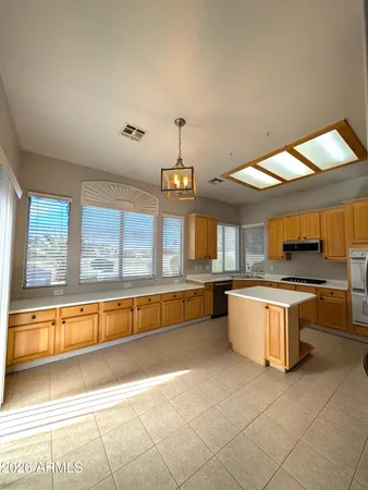 a kitchen with stainless steel appliances granite countertop a sink and a stove