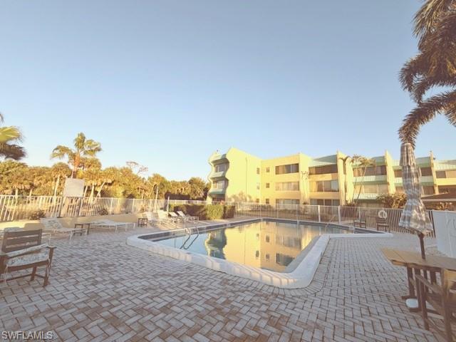 925 Palm View Drive, Unit 121 Naples, FL 34110 - Photo 12 of 13 Community pool with a patio area