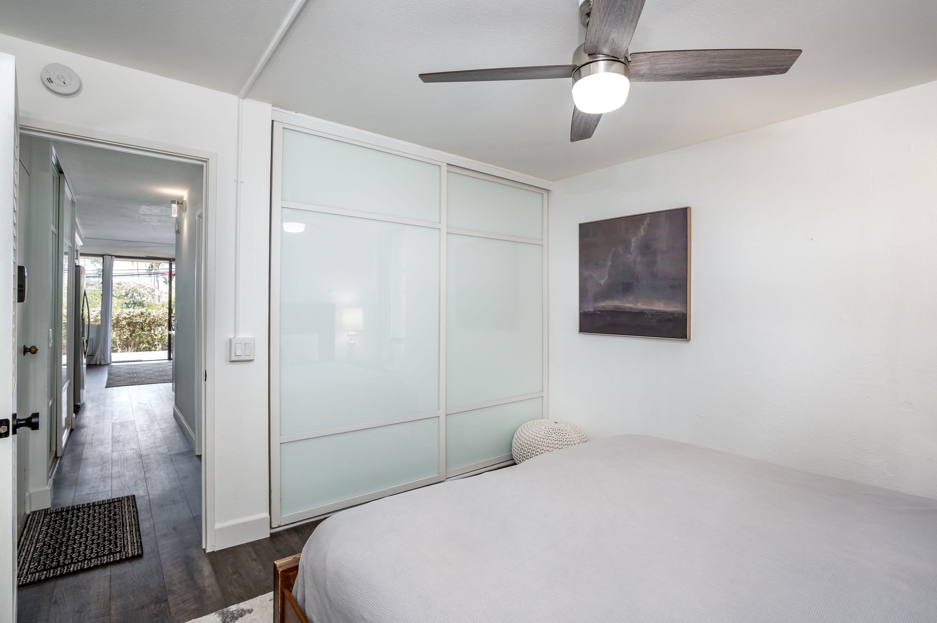 2191 South Kihei Road, Unit 1118 Kihei, HI 96753 - Photo 12 of 40 a bedroom with a bed and a chandelier