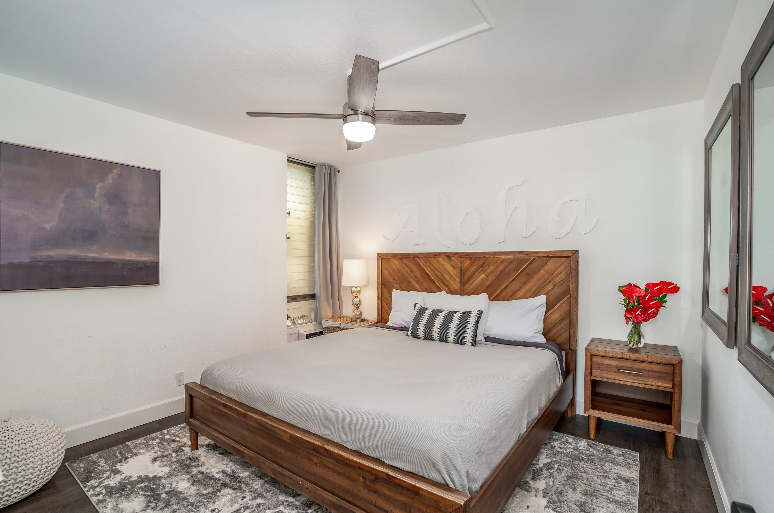 2191 South Kihei Road, Unit 1118 Kihei, HI 96753 - Photo 14 of 40 a bedroom with a bed and a chandelier