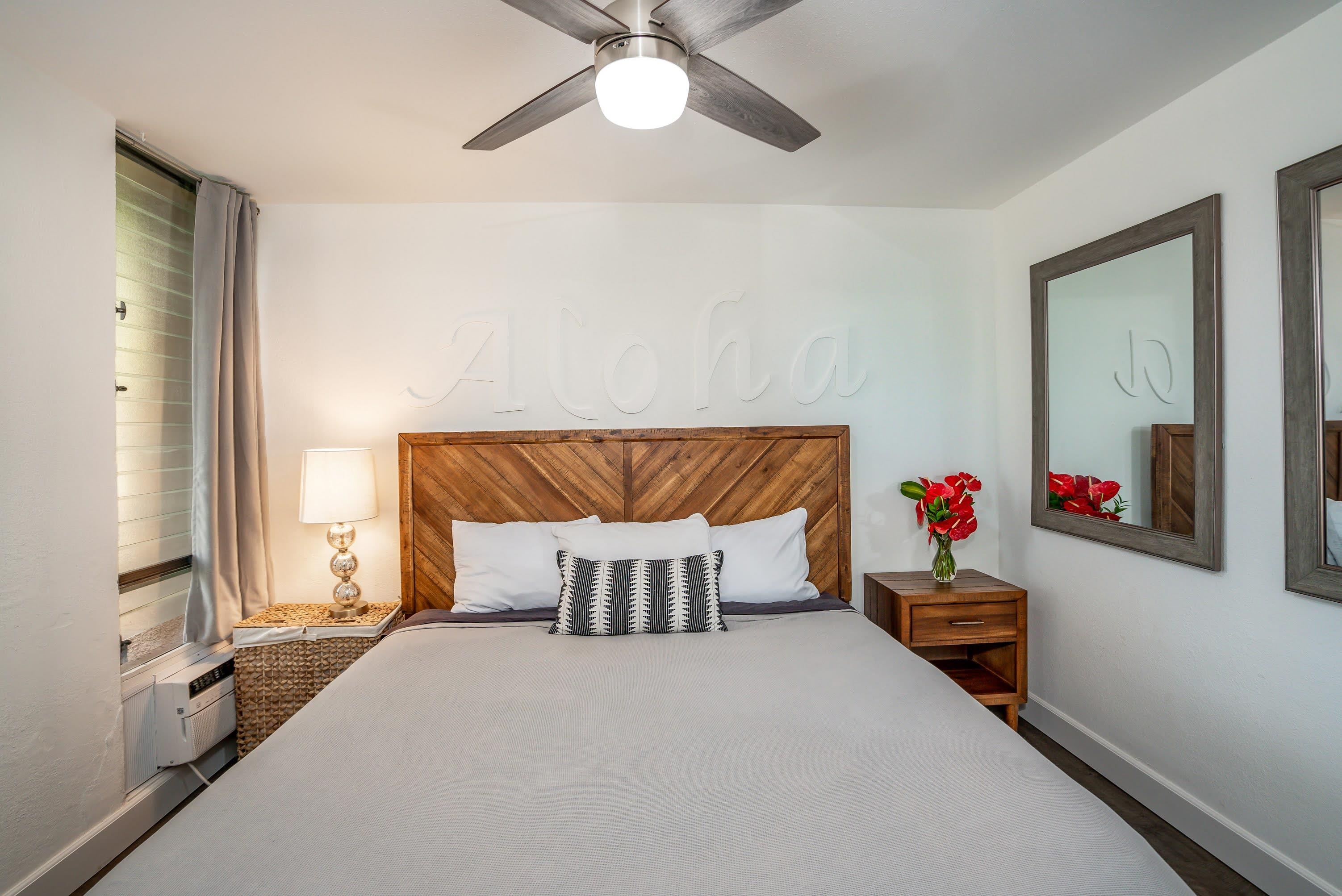 2191 South Kihei Road, Unit 1118 Kihei, HI 96753 - Photo 15 of 40 a bedroom with a bed and a chandelier