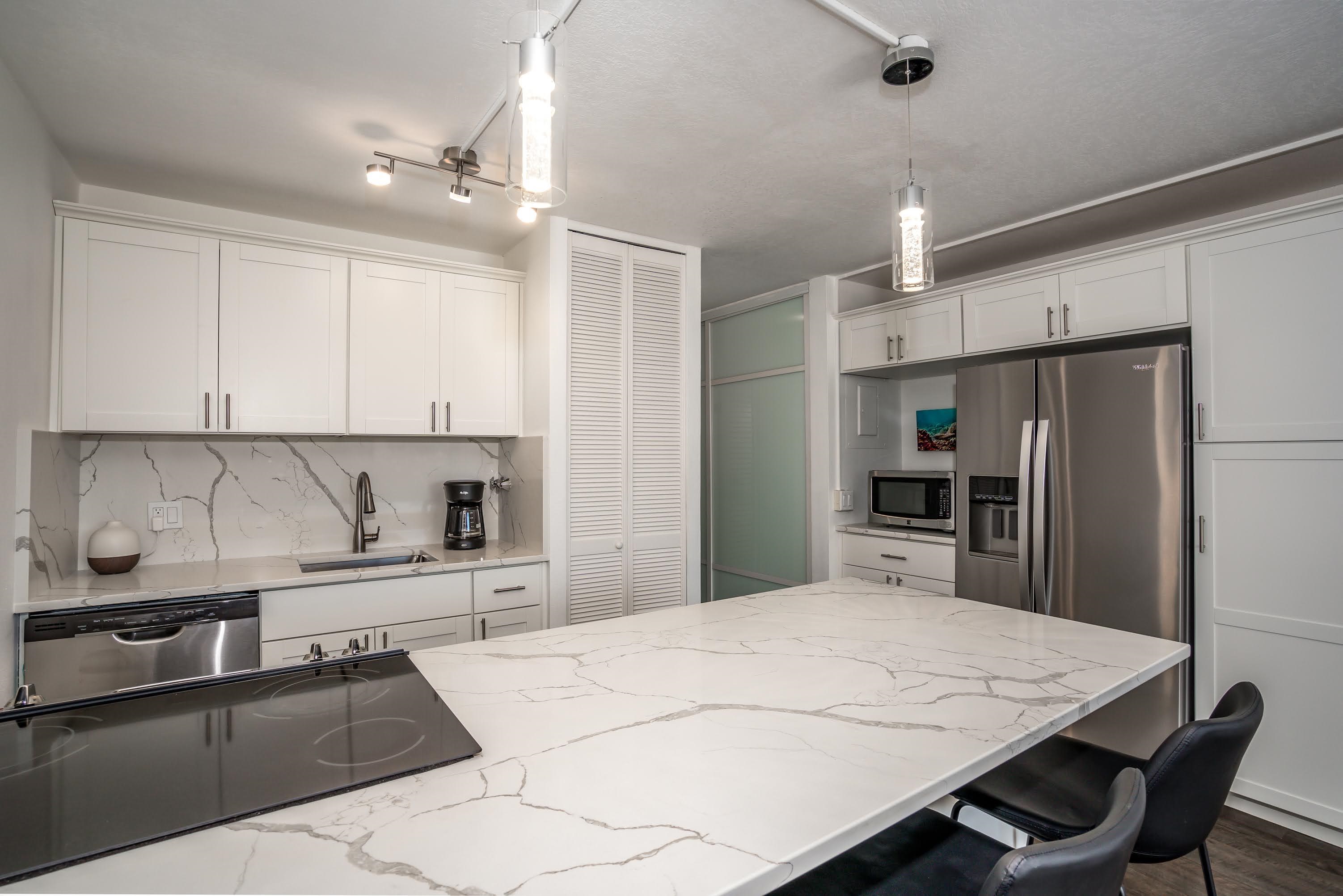2191 South Kihei Road, Unit 1118 Kihei, HI 96753 - Photo 5 of 40 a kitchen with granite countertop a sink appliances and cabinets