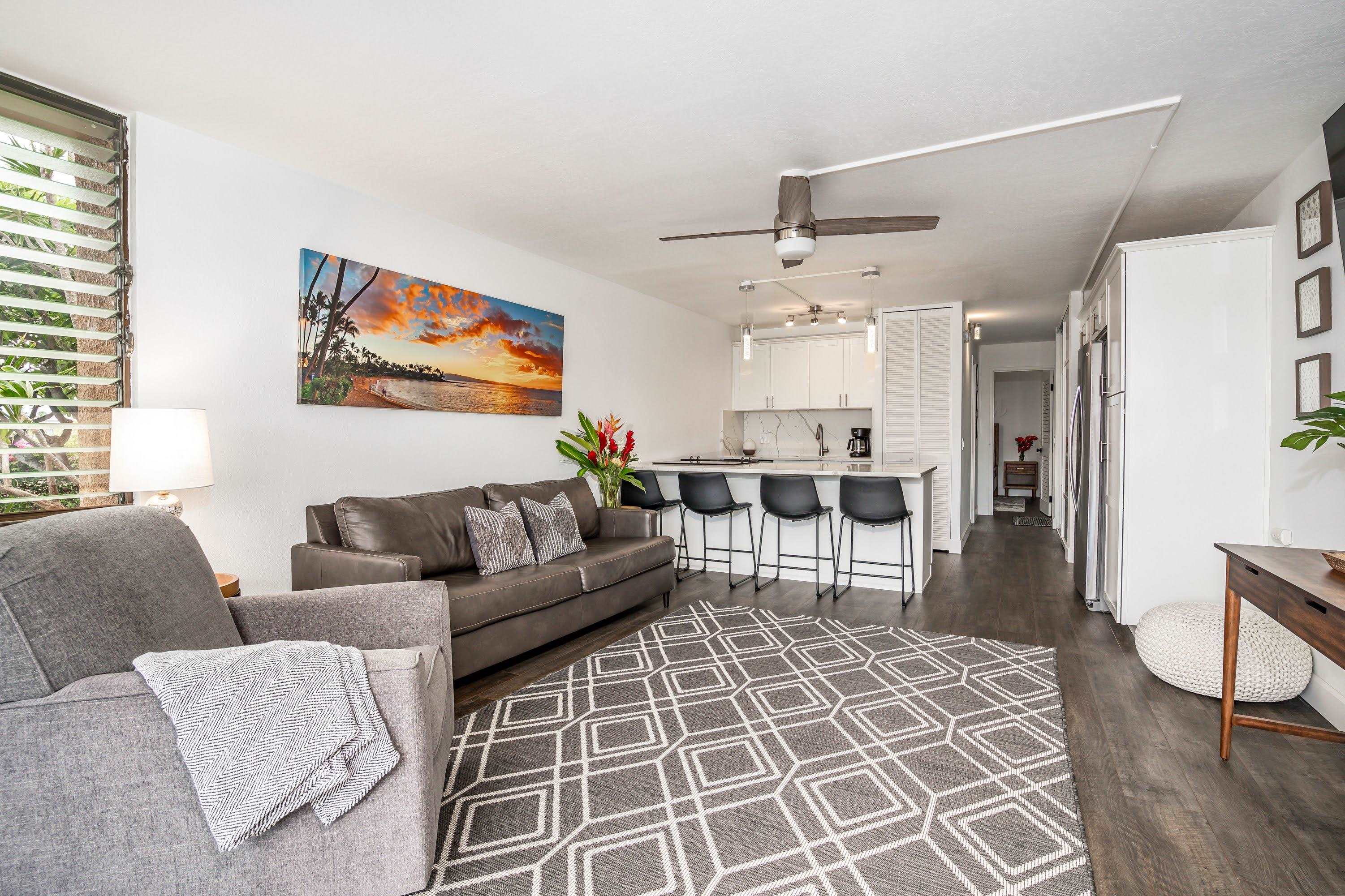 2191 South Kihei Road, Unit 1118 Kihei, HI 96753 - Photo 7 of 40 a living room with furniture a flat screen tv and kitchen view