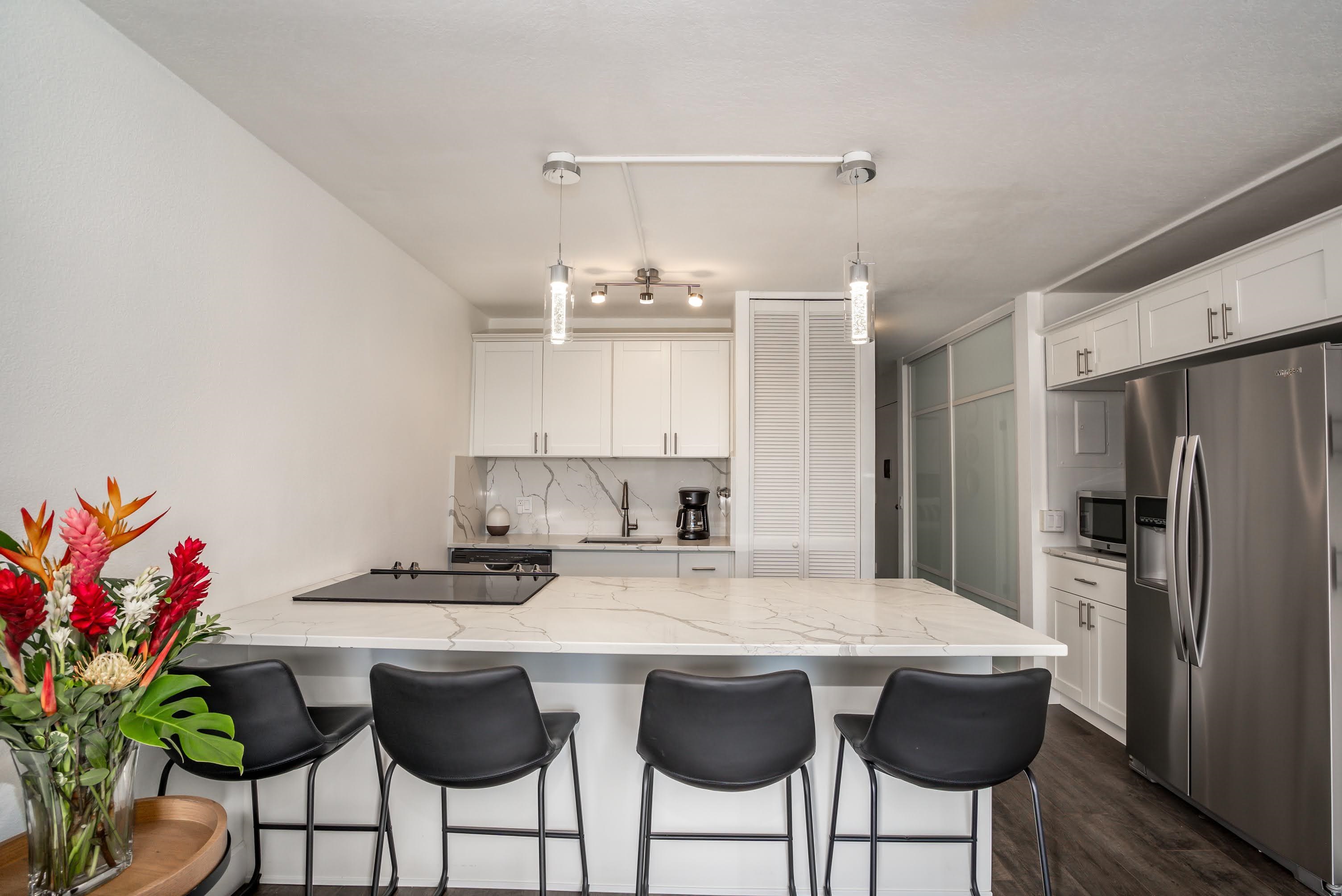 2191 South Kihei Road, Unit 1118 Kihei, HI 96753 - Photo 8 of 40 a kitchen with granite countertop a counter space a sink stainless steel appliances and cabinets