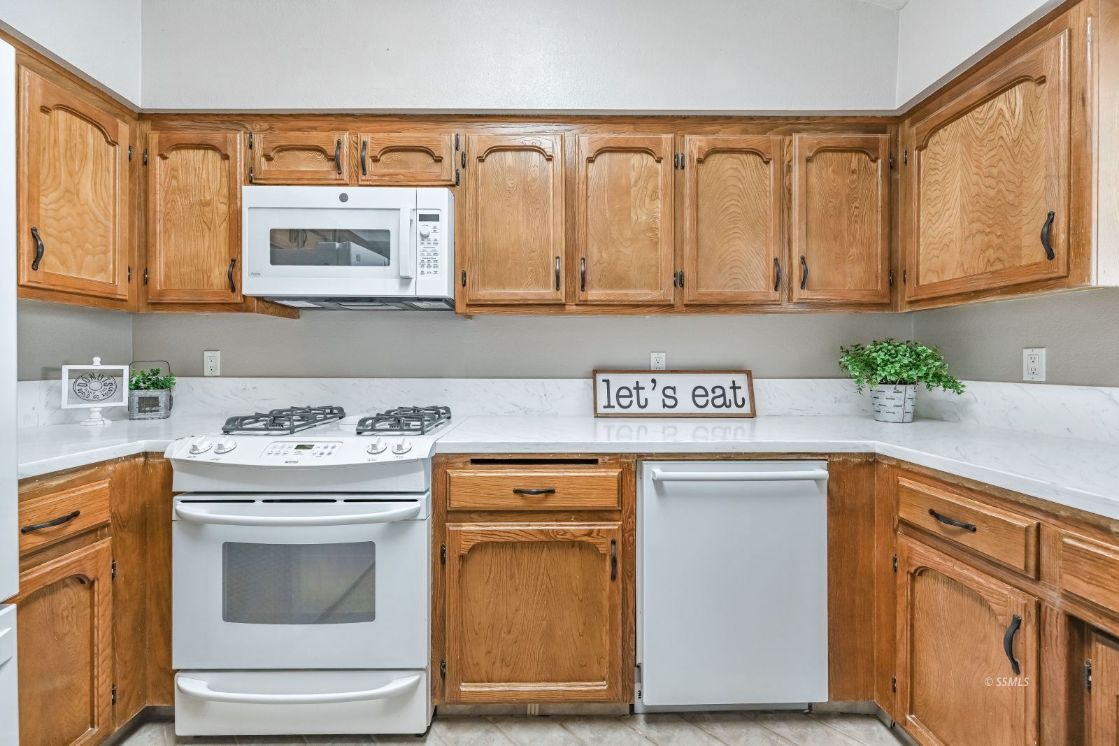 131 Chambers Street Ridgecrest, CA 93555 - Photo 4 of 28 a kitchen with stainless steel appliances granite countertop a stove a sink and a microwave