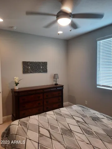 a bed sitting in a bedroom next to a window