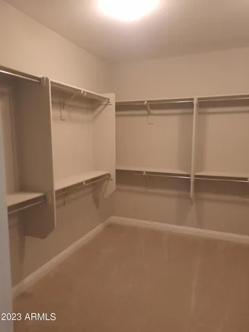 a white toilet sitting next to a white wall