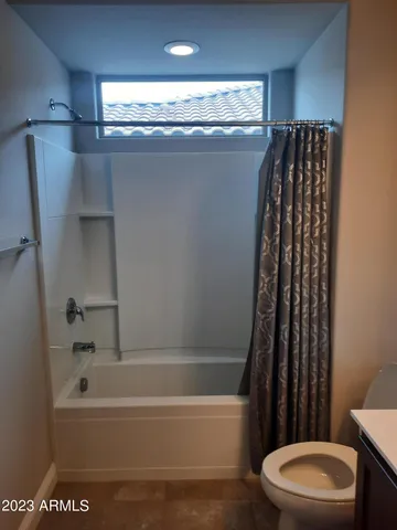 a bathroom with a toilet and a bathtub