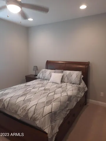 a bed sitting in a bedroom next to a bathroom