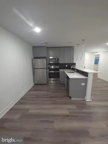 a view of kitchen with wooden cabinet