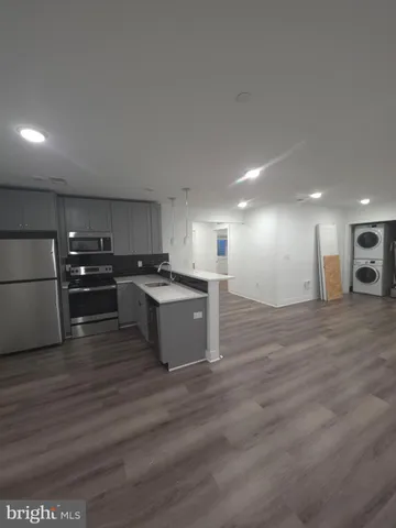 a large kitchen with stainless steel appliances granite countertop a large counter top and a stove