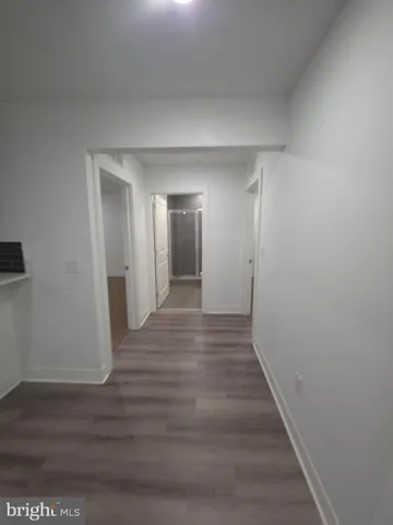 a view of hallway with wooden floor