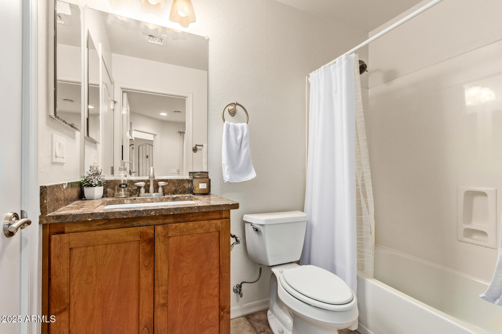 6940 East Cochise Road, Unit 1016 Paradise Valley, AZ 85253 - Photo 24 of 39 a bathroom with a granite countertop toilet sink and mirror