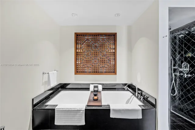 a bathroom with a sink a mirror a vanity and a shower