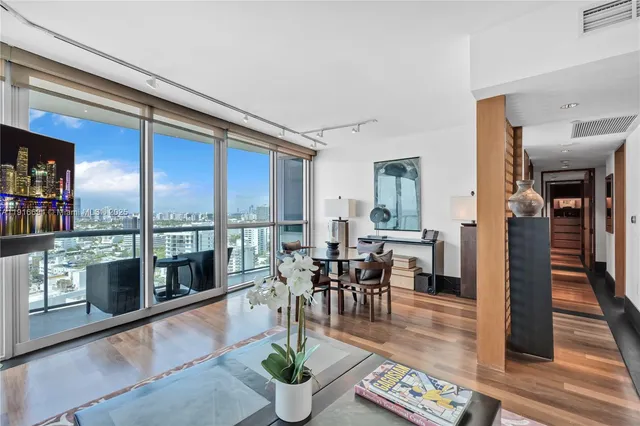a dining room with furniture a rug and a painting