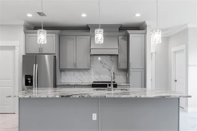 a kitchen with a refrigerator stove and cabinets