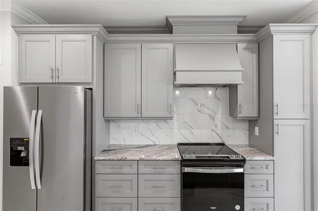 a kitchen with stainless steel appliances granite countertop a refrigerator and a sink