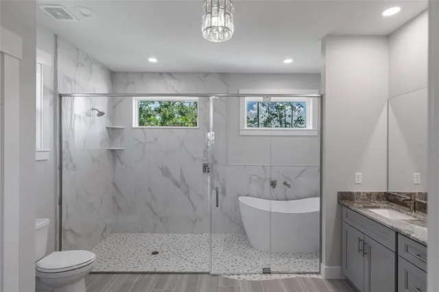 a large kitchen with granite countertop a large counter top appliances and cabinets