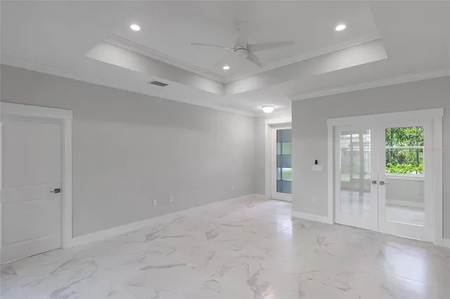 an empty room with sliding door and wooden floor