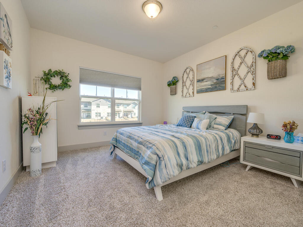 2257 Local Rebel Loop Leander, TX 78641 - Photo 15 of 26 a spacious bedroom with a bed and a window